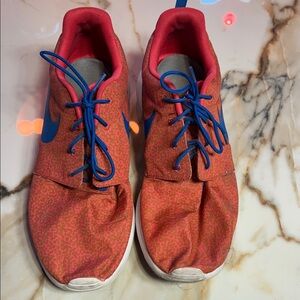 Nike Red Patterned Sneakers with Blue Swoosh and Laces